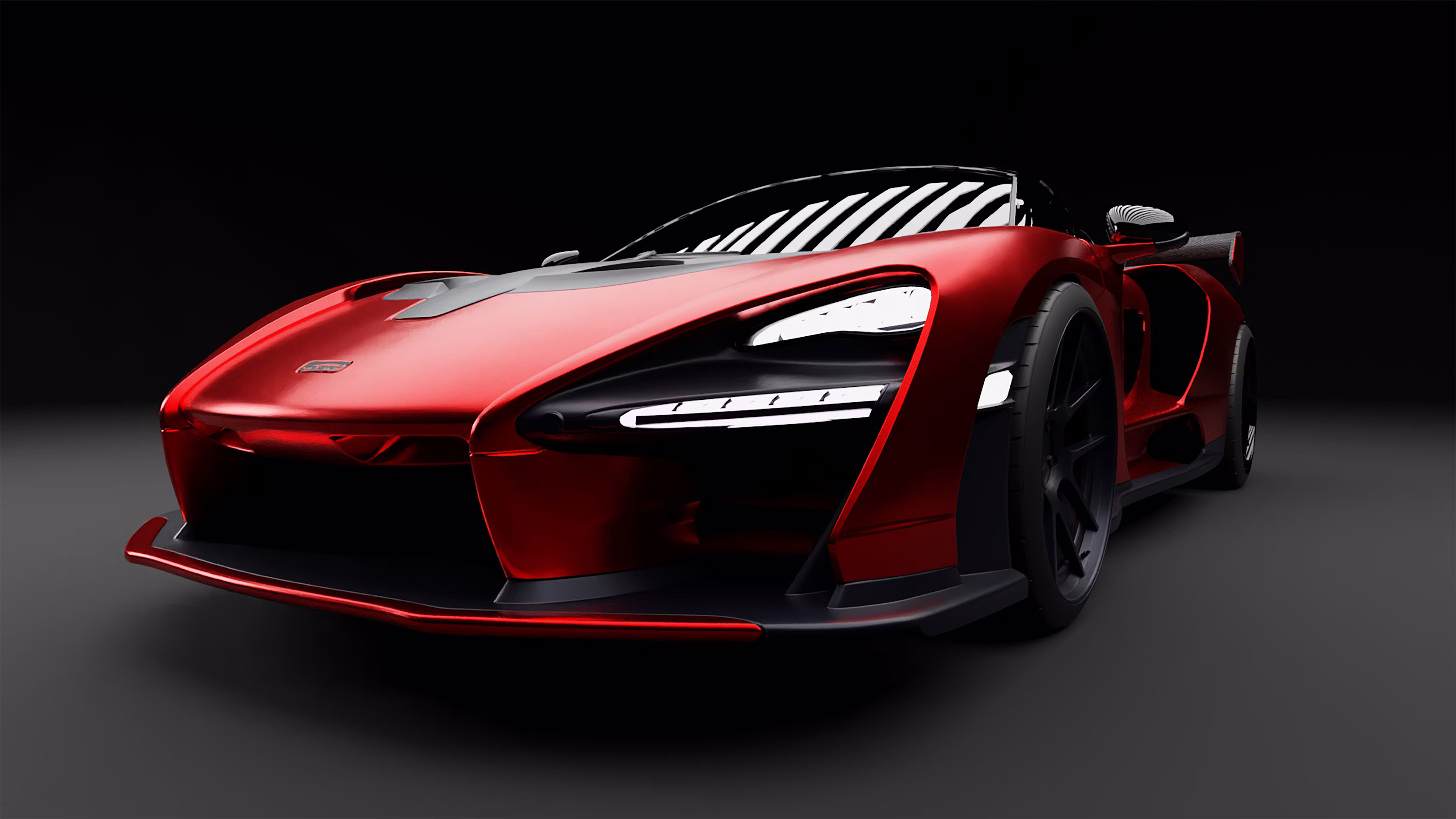 Metallic red sports car in a dark studio